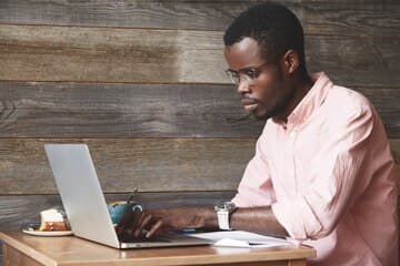 Examiner creating an exam on a laptop
